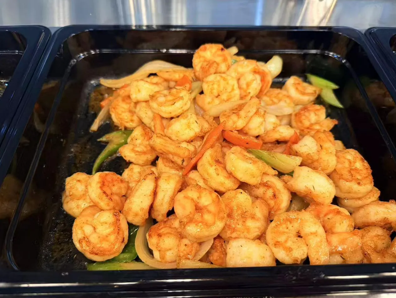 Stir-fried seasoned shrimp mixed with onion, celery and carrot strips in tray at Sam Bistro Thai Restaurant in Middletown