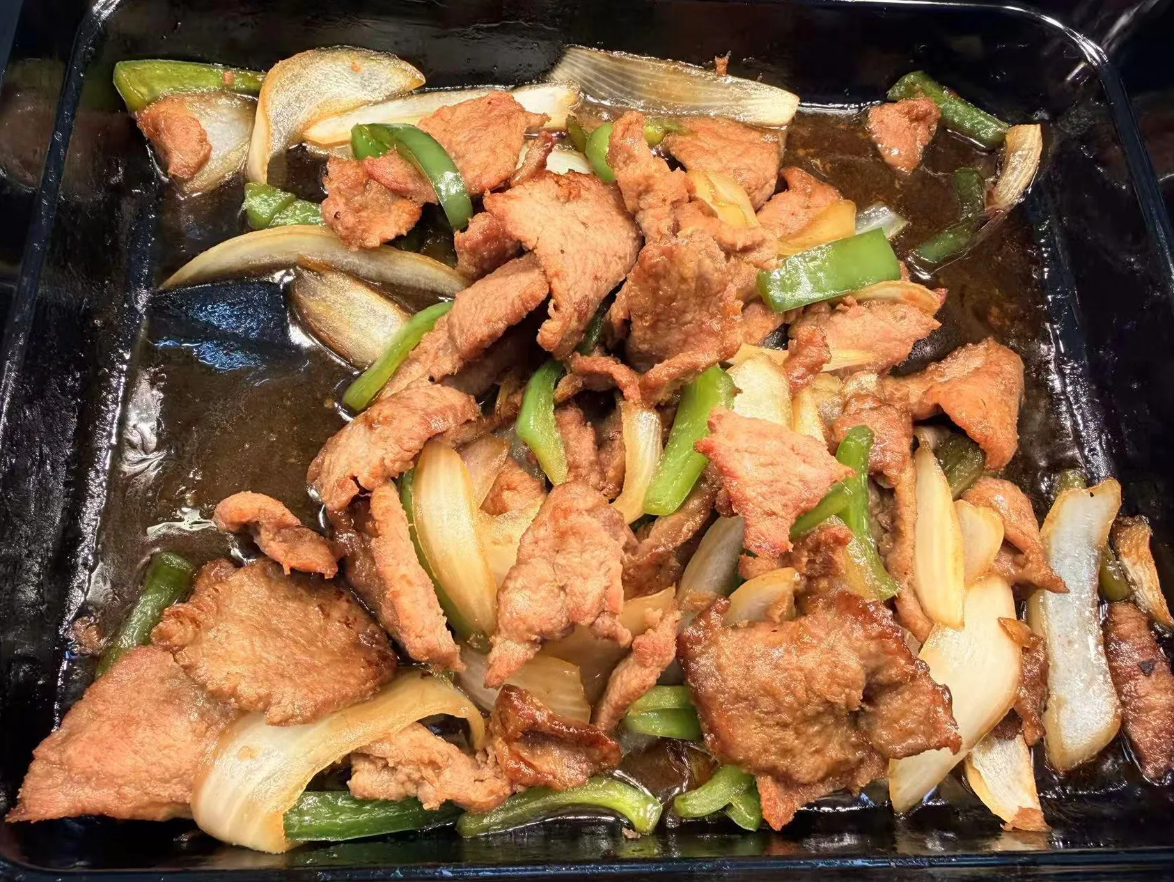 Stir-fried pork slices with green bell pepper and white onion wedges at Sam Bistro Thai Restaurant in Middletown